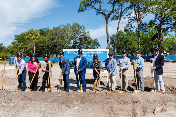 Mayor City Council and other people of importance posing with shovels at ground breaking
